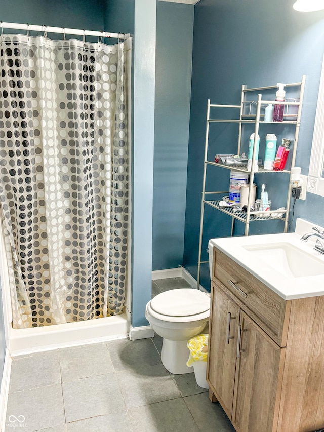 bathroom with toilet, a shower stall, and vanity