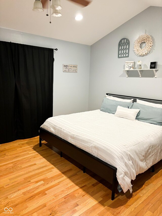 bedroom with lofted ceiling, recessed lighting, and wood finished floors