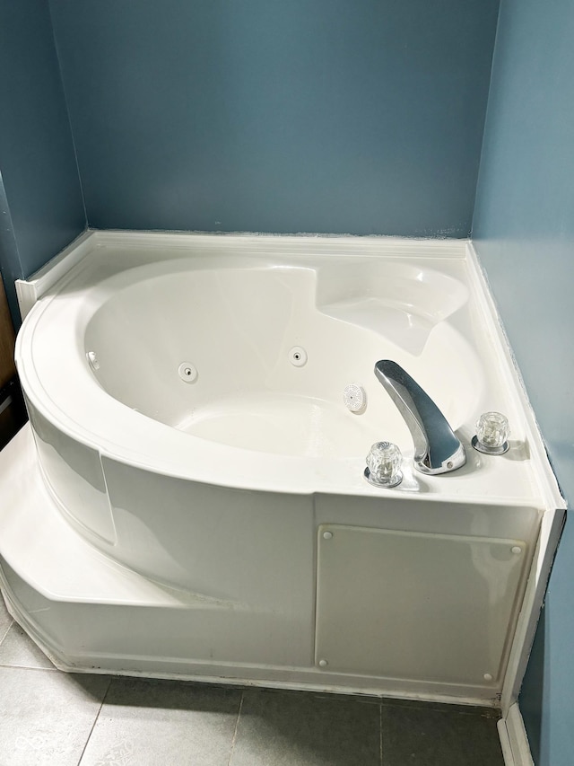 bathroom with a jetted tub and tile patterned flooring