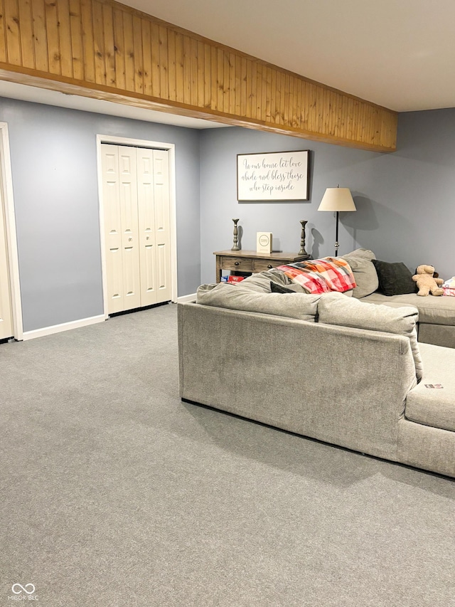 carpeted living area with baseboards