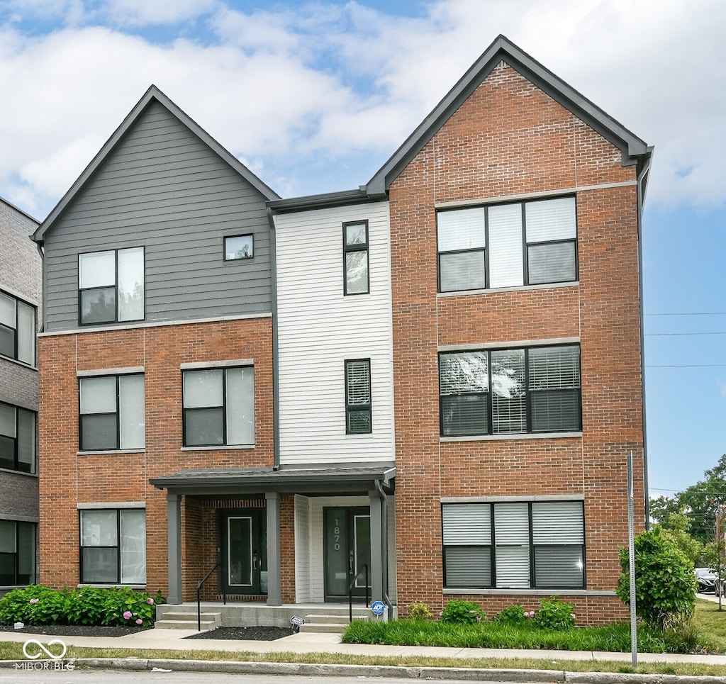 townhome / multi-family property with brick siding