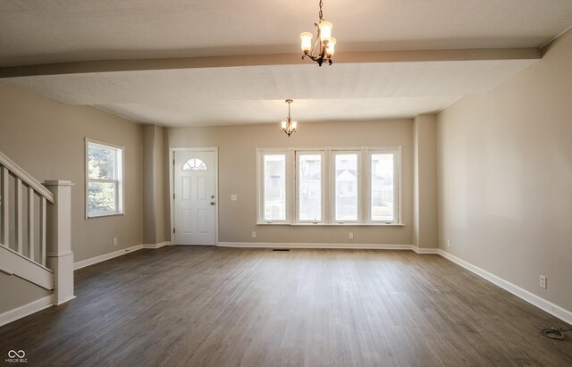 foyer entrance featuring an inviting chandelier, dark hardwood / wood-style flooring, and a healthy amount of sunlight