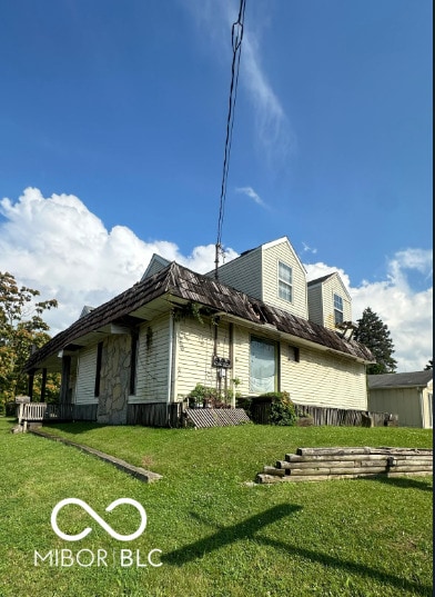 view of property exterior featuring a lawn