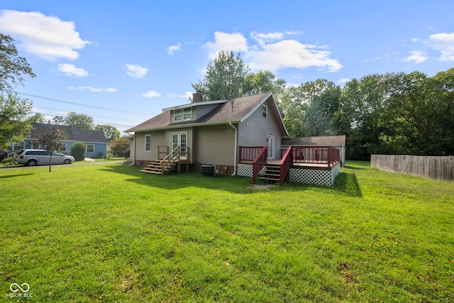 back of property featuring central AC unit, a lawn, and a wooden deck