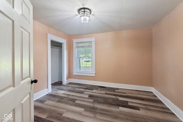 bedroom featuring dark hardwood / wood-style floors and a closet