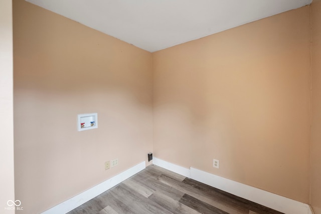 clothes washing area featuring washer hookup and light hardwood / wood-style flooring