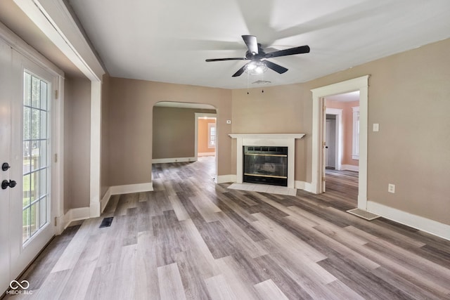 unfurnished living room with ceiling fan and wood-type flooring