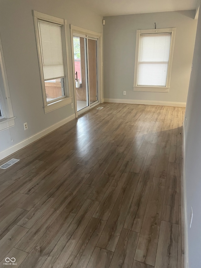 unfurnished room featuring dark hardwood / wood-style flooring