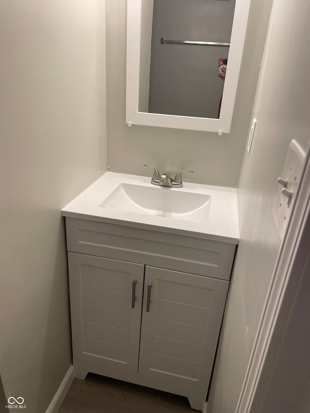 bathroom featuring hardwood / wood-style flooring and vanity