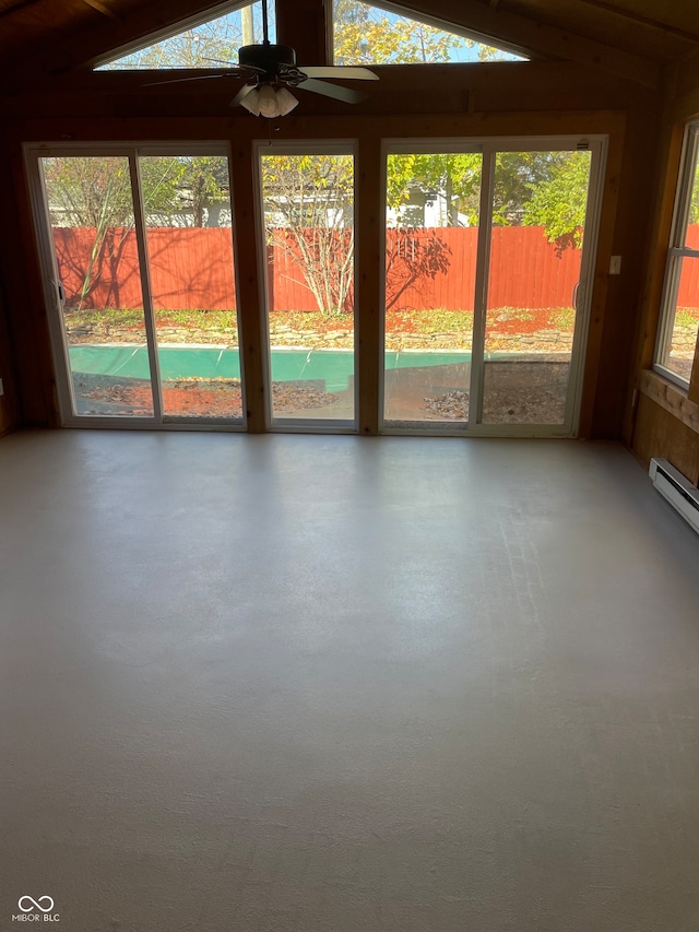 unfurnished sunroom with ceiling fan, plenty of natural light, and lofted ceiling