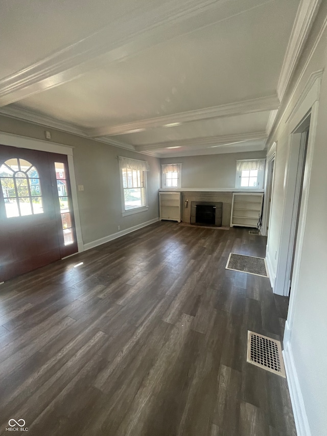 unfurnished living room featuring dark hardwood / wood-style flooring, crown molding, and plenty of natural light