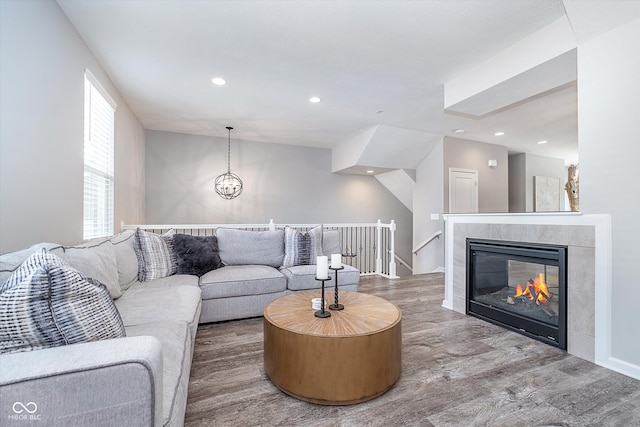 living room featuring hardwood / wood-style flooring and a tiled fireplace