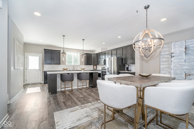 dining room with a notable chandelier and hardwood / wood-style floors