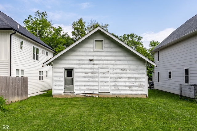 rear view of property with a yard