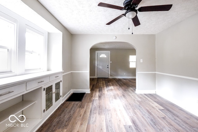 interior space with hardwood / wood-style floors, a textured ceiling, and ceiling fan