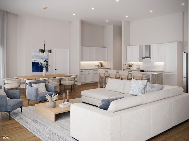 living room with hardwood / wood-style floors and a high ceiling