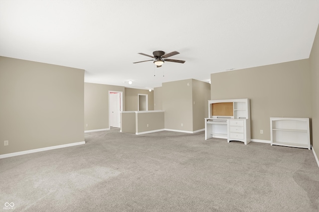 unfurnished living room featuring ceiling fan and light carpet