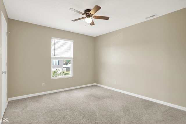 carpeted spare room featuring ceiling fan