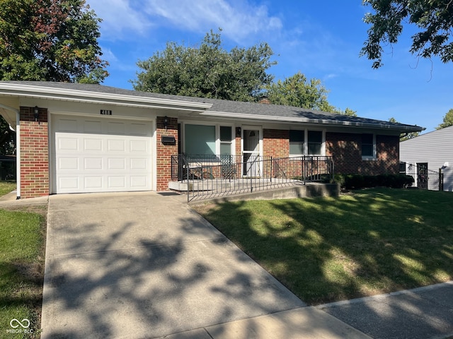 single story home featuring a garage and a front yard