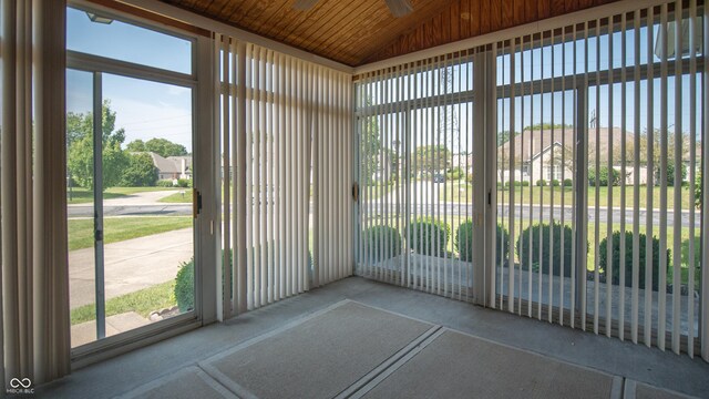 unfurnished sunroom with wooden ceiling and vaulted ceiling