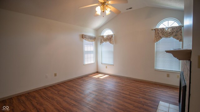 unfurnished living room featuring hardwood / wood-style flooring, vaulted ceiling, and ceiling fan