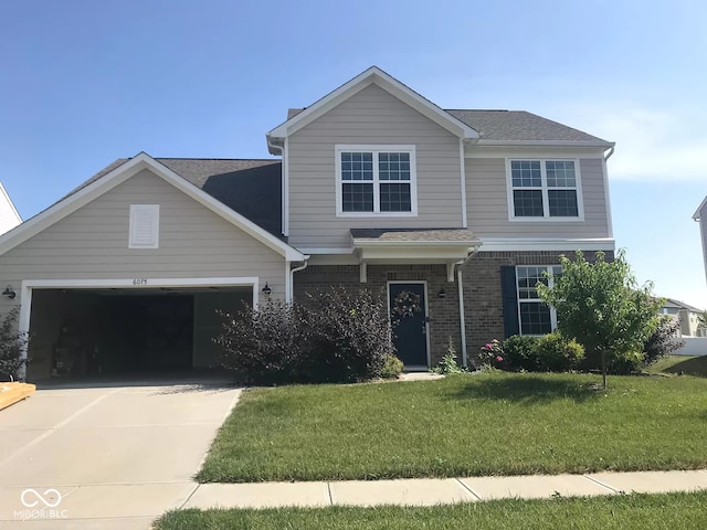 view of front property with a garage and a front yard