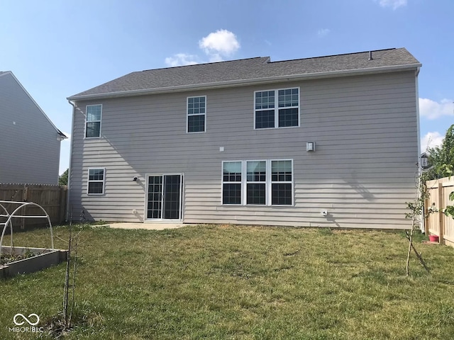 back of house featuring a yard and a patio area