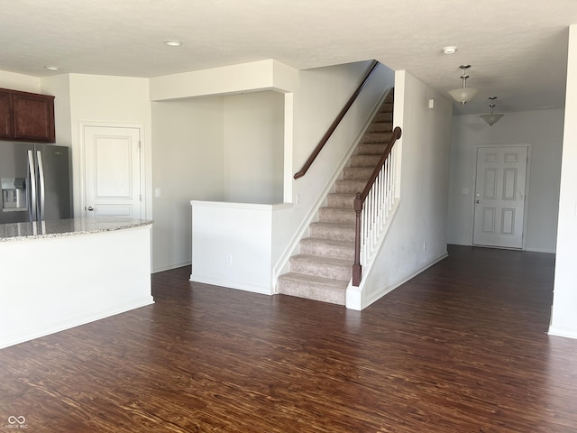 unfurnished living room with dark hardwood / wood-style flooring