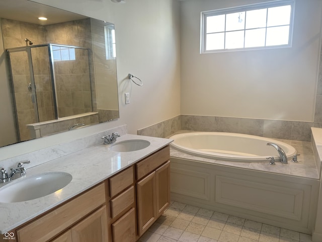 bathroom with vanity and shower with separate bathtub