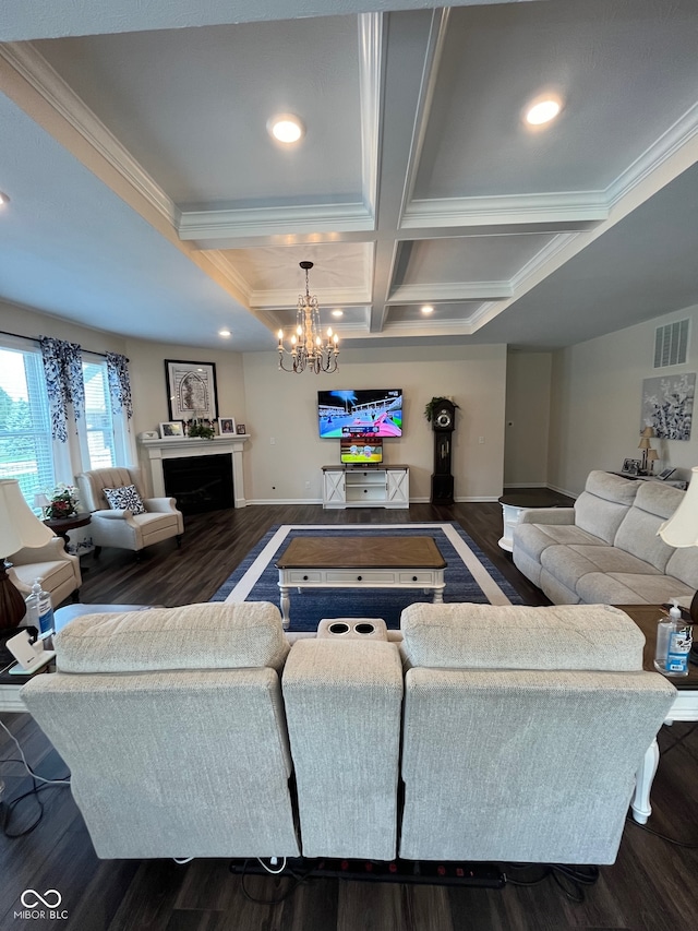 living room with hardwood / wood-style flooring, crown molding, coffered ceiling, and an inviting chandelier