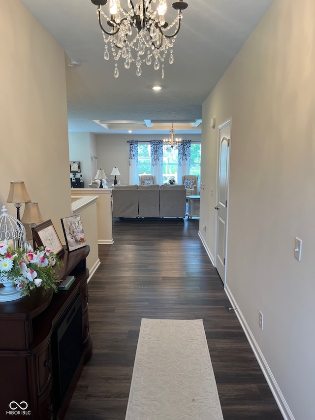 hallway featuring a notable chandelier and dark hardwood / wood-style flooring