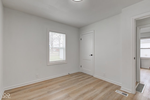 spare room featuring light hardwood / wood-style floors