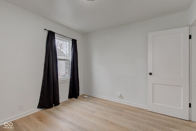 unfurnished room with light hardwood / wood-style floors