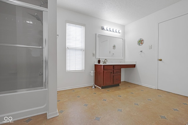 bathroom with vanity, tile patterned floors, enclosed tub / shower combo, and a textured ceiling