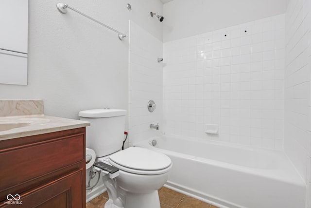 full bathroom featuring vanity, tiled shower / bath, tile patterned floors, and toilet