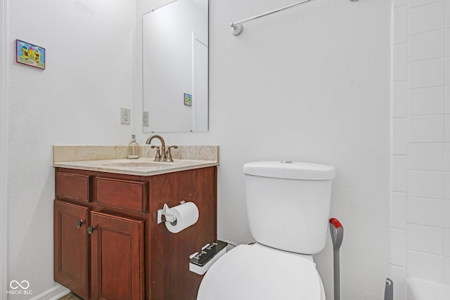 bathroom featuring vanity, walk in shower, and toilet