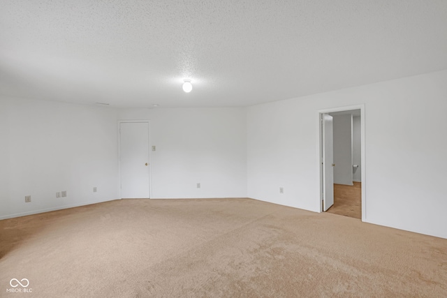 carpeted empty room with a textured ceiling