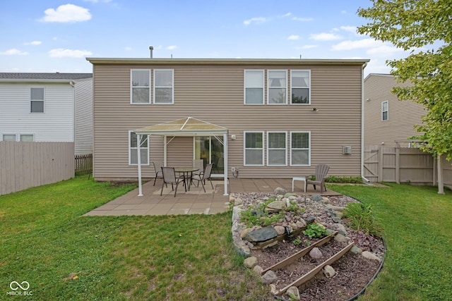 back of house featuring a yard and a patio