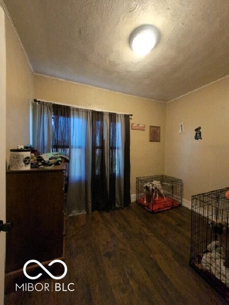 bedroom with a textured ceiling and hardwood / wood-style floors