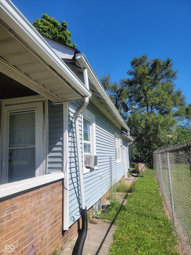 view of side of home with a lawn