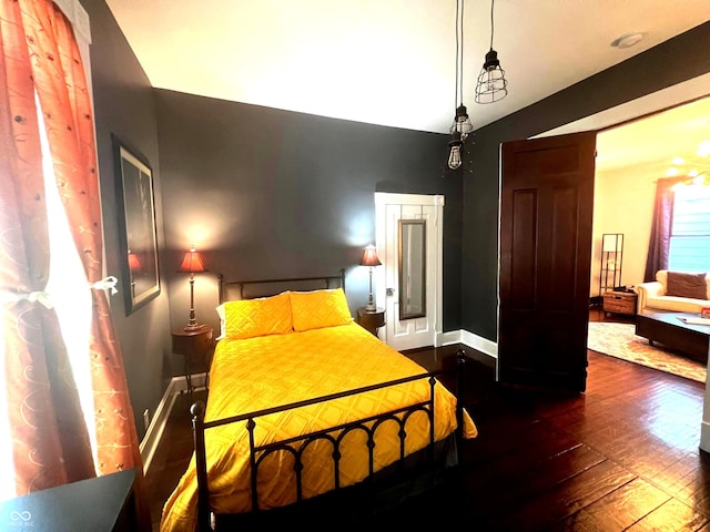 bedroom featuring dark wood-type flooring and vaulted ceiling