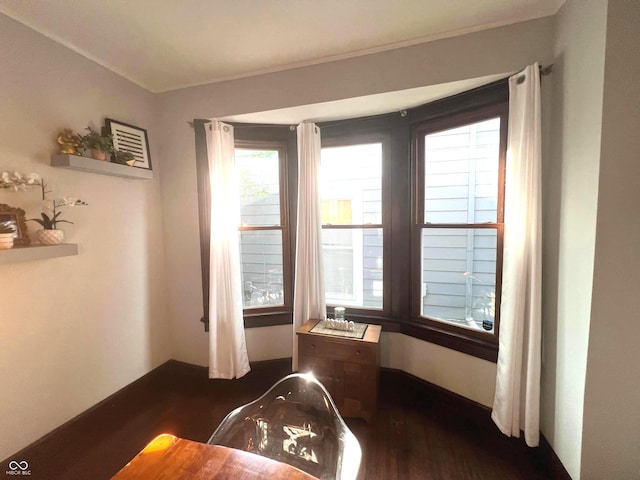 interior space with ornamental molding and dark hardwood / wood-style floors