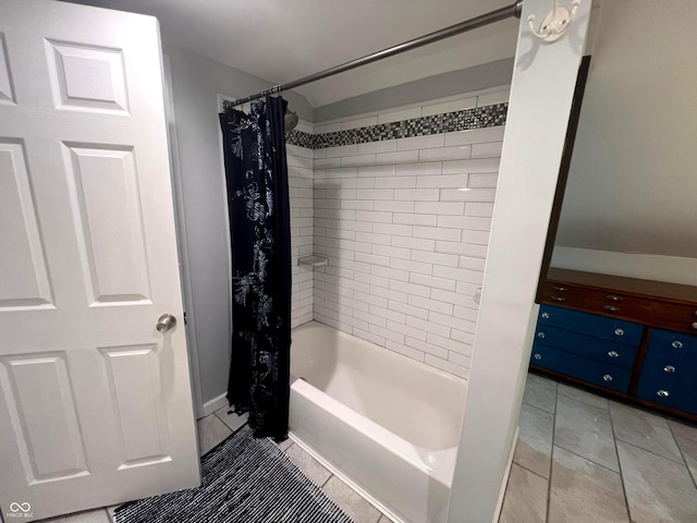 bathroom with shower / bath combination with curtain and tile patterned floors