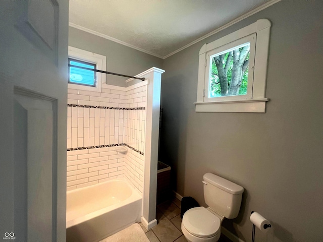 bathroom with toilet, tiled shower / bath combo, crown molding, and tile patterned floors