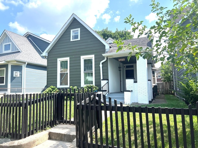 bungalow-style house with a front yard