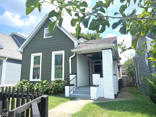 bungalow-style house featuring a front lawn