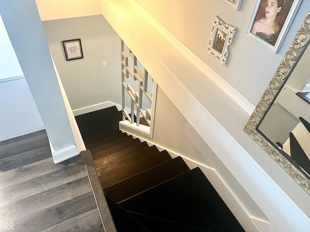 stairway featuring wood-type flooring