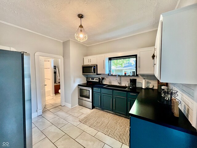 kitchen featuring pendant lighting, sink, decorative backsplash, appliances with stainless steel finishes, and white cabinets