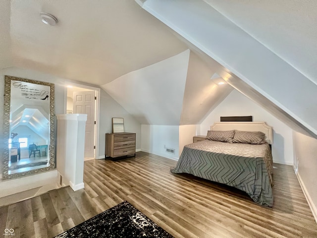 bedroom with hardwood / wood-style floors and vaulted ceiling