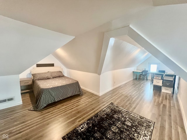 bedroom featuring vaulted ceiling and wood-type flooring